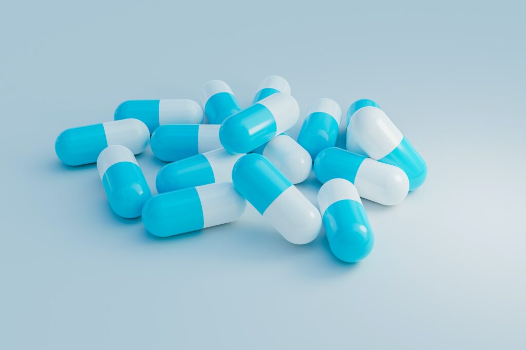 blue and white capsules medication