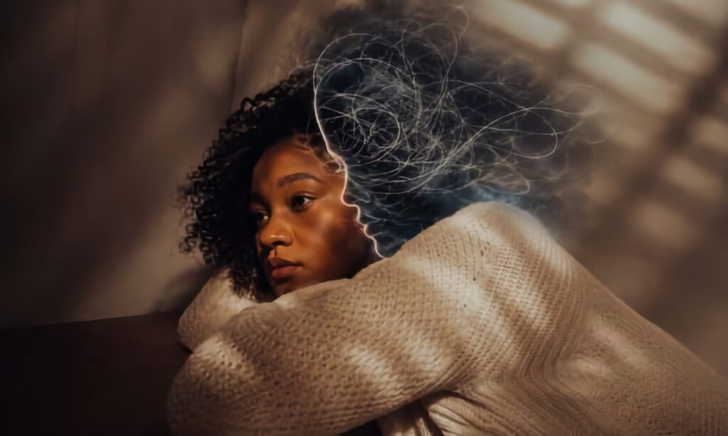 Woman in deep thought with negative mental health manifestation clouding her head